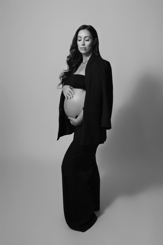 Vogue-inspired maternity photography in Oklahoma City, black suit with high-fashion studio lighting