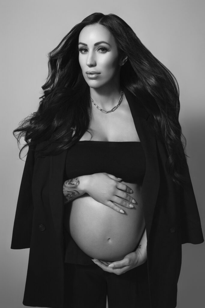 Editorial black and white maternity portrait in Oklahoma City with black suit and magazine lighting