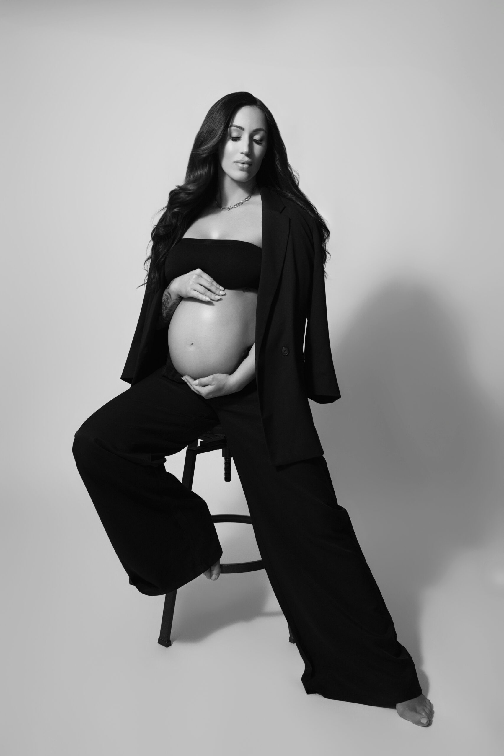 Luxury editorial maternity photography in Oklahoma City featuring black suit, black and white style
