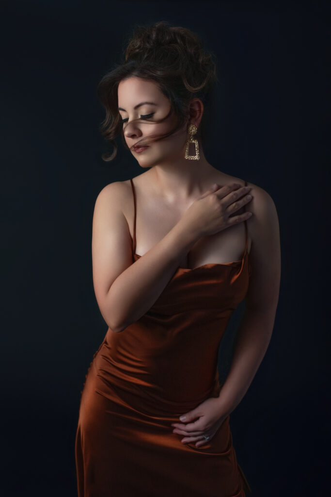 Woman in a bronze dress photographed in an intimate fine art portrait session in Oklahoma City studio.