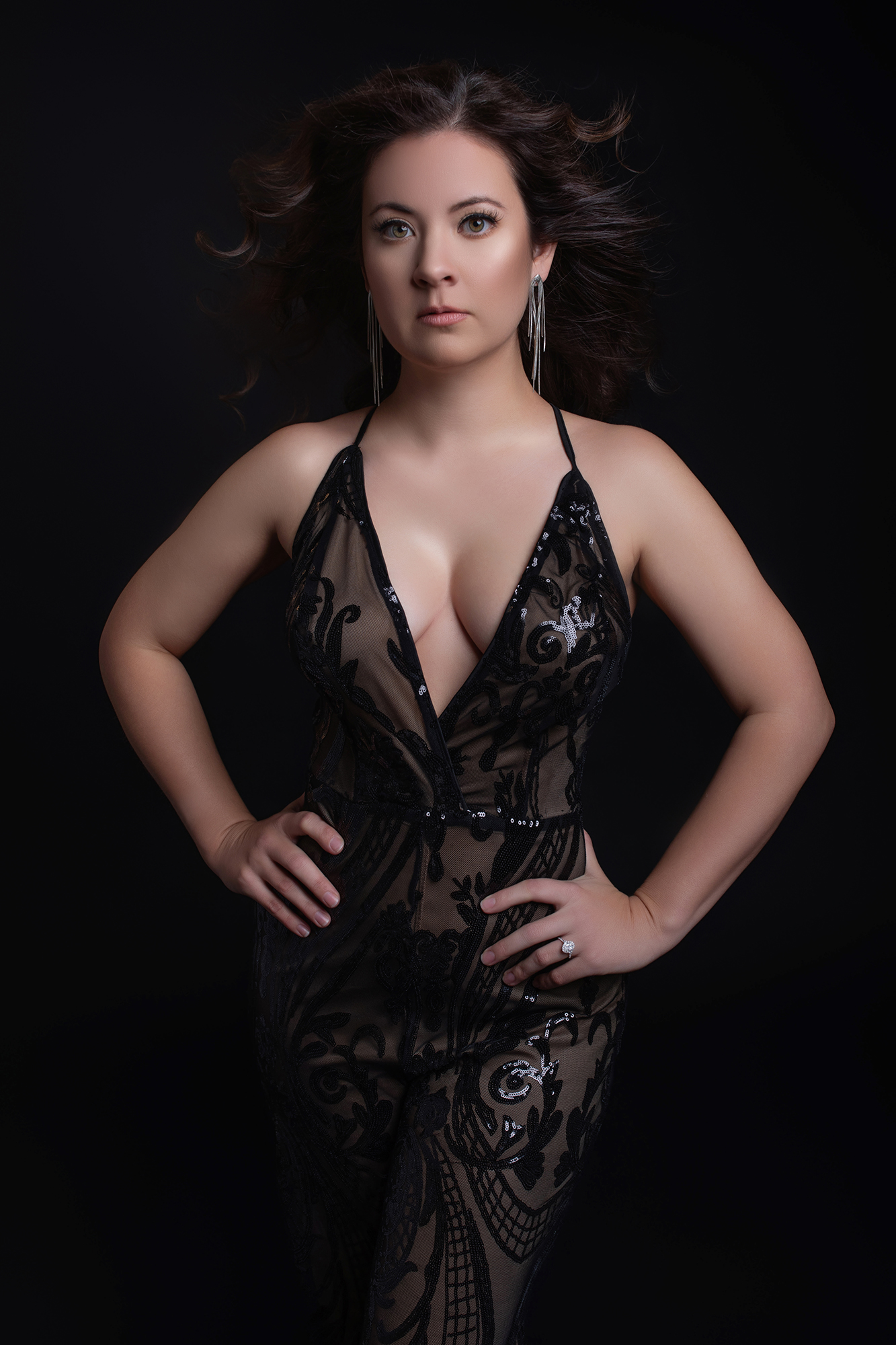 Woman wearing black lace gown during couture portrait photography session